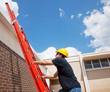 Worker practicing safe ladder use