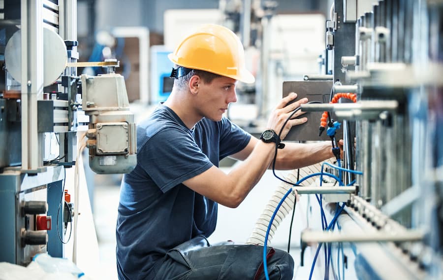 male industrial maintenance worker at machine