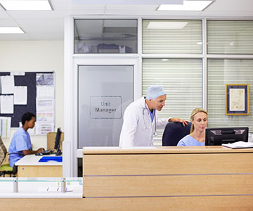 Medical billing and coding staff working with doctor