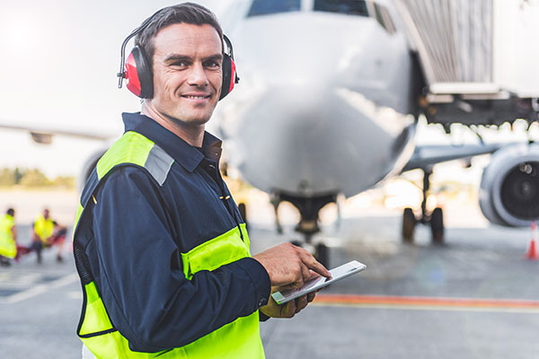 technician reviewing clipboard on runway