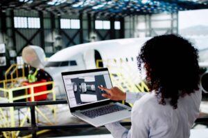 Airplane Maintenance At Airport. Woman Using Laptop